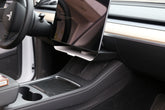 An interior side view of the Tesla Y under screen storage accessory installed