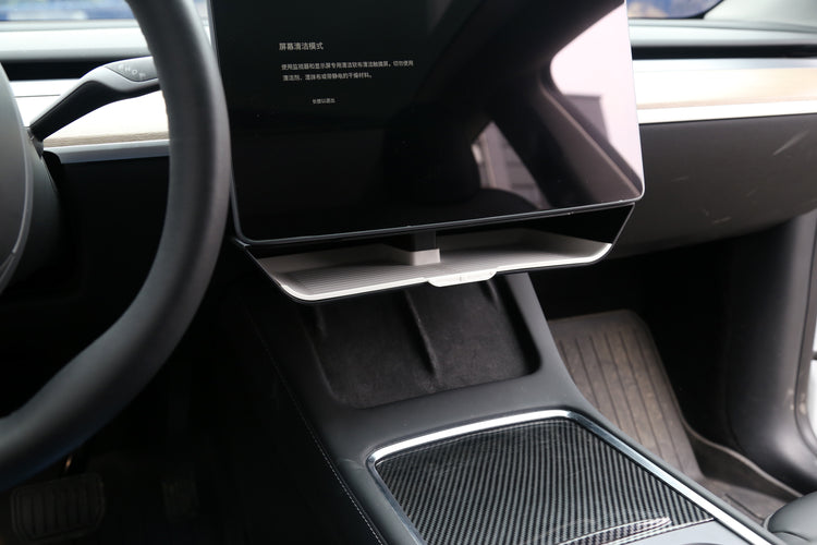 An interior view of the Tesla Y under screen storage accessory installed