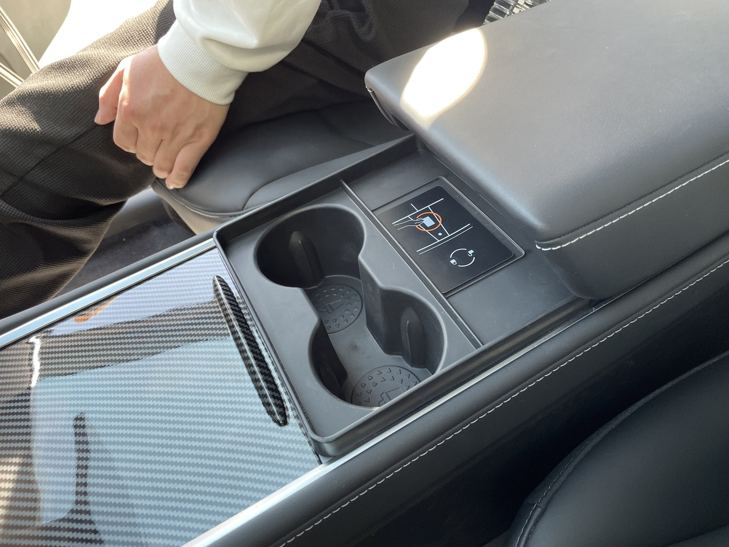 A side view of the interior of the Tesla Y Cup Holder Accessory installed with a Tesla Key Card on top